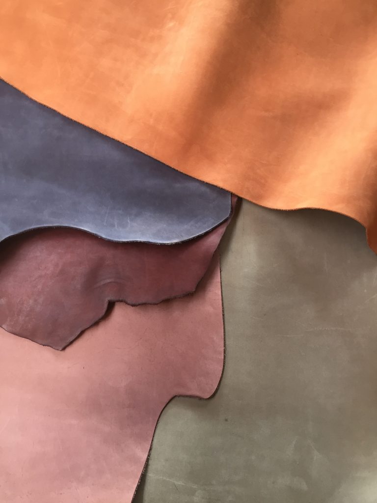 Differently coloured layers of leather displayed on a table