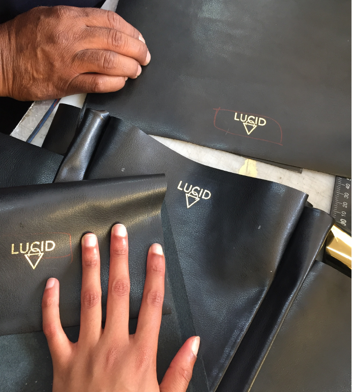 Two hands working on LUCID X Treasure Baloyi Holster Collaboration