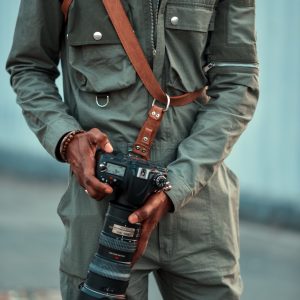 Lucid X Treasure Baloyi Camera Strap by Madi Lucent held by photographer